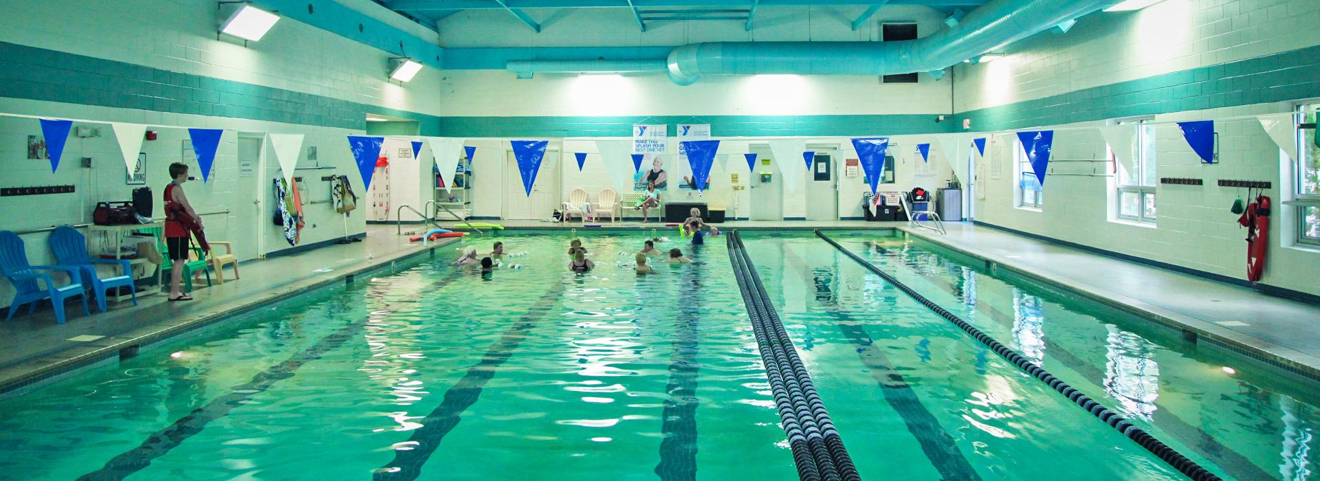 Members swimming in the 25-yard indoor lap swimming pool at the Hilltop Family YMCA