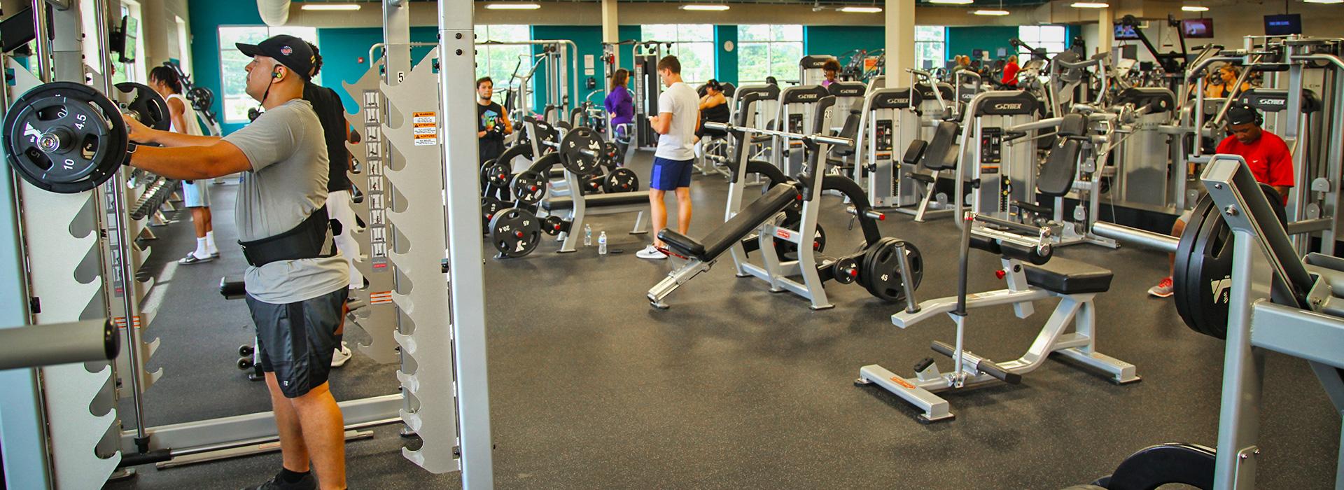 Squat rack and other free weight equipment in the wellness center of the Princess Anne Family YMCA