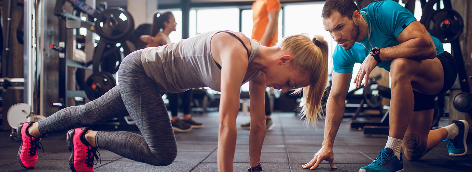 Woman working out with the instruction of a personal trainer