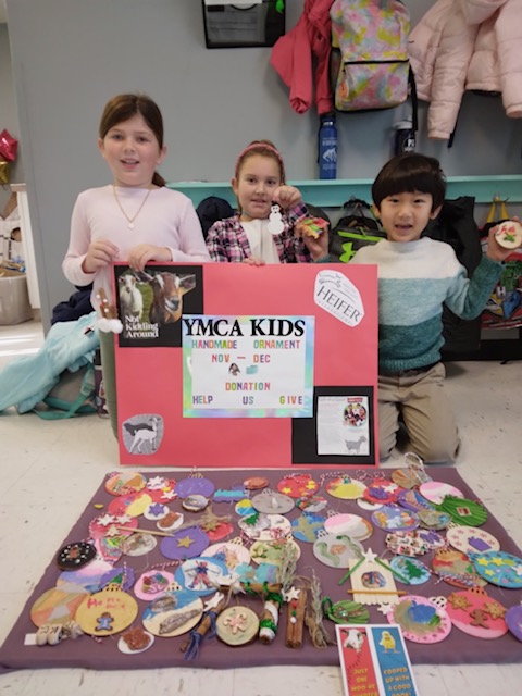 Kids proudly displaying handmade ornaments