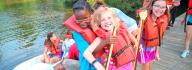 kids playing around kayaks