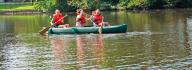 kids on a kayak in a pond