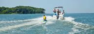 boat in ocean with child kneeboarding