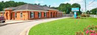 Exterior image of Salem YMCA Family Center with grass and flowers in foreground