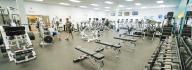 Members working out in the free weight area of the wellness center at the Hilltop Family YMCA