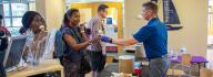 Volunteers serve ice cream cones to community members who attended the YMCA on Granby's 10th anniversary celebration