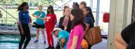 YMCA donors smile and chat while watching campers swim in the YMCA Camp Arrowhead pool