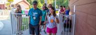 YMCA staff and donors have conversation while walking outside at YMCA at JT's Camp Grom