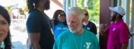 YMCA staff and donors have conversation while walking outside at YMCA at JT's Camp Grom