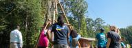 YMCA donors look at the Alpine Climbing Tower at YMCA at JT's Camp Grom