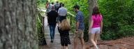 Camp donors walk along the fishing pier at YMCA Camp Red Feather