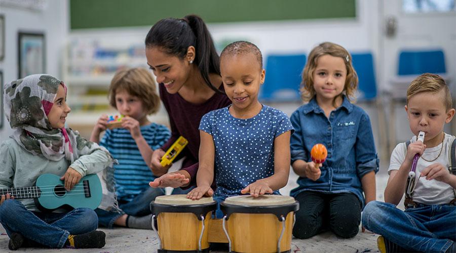 Group of children playing instruments in a class