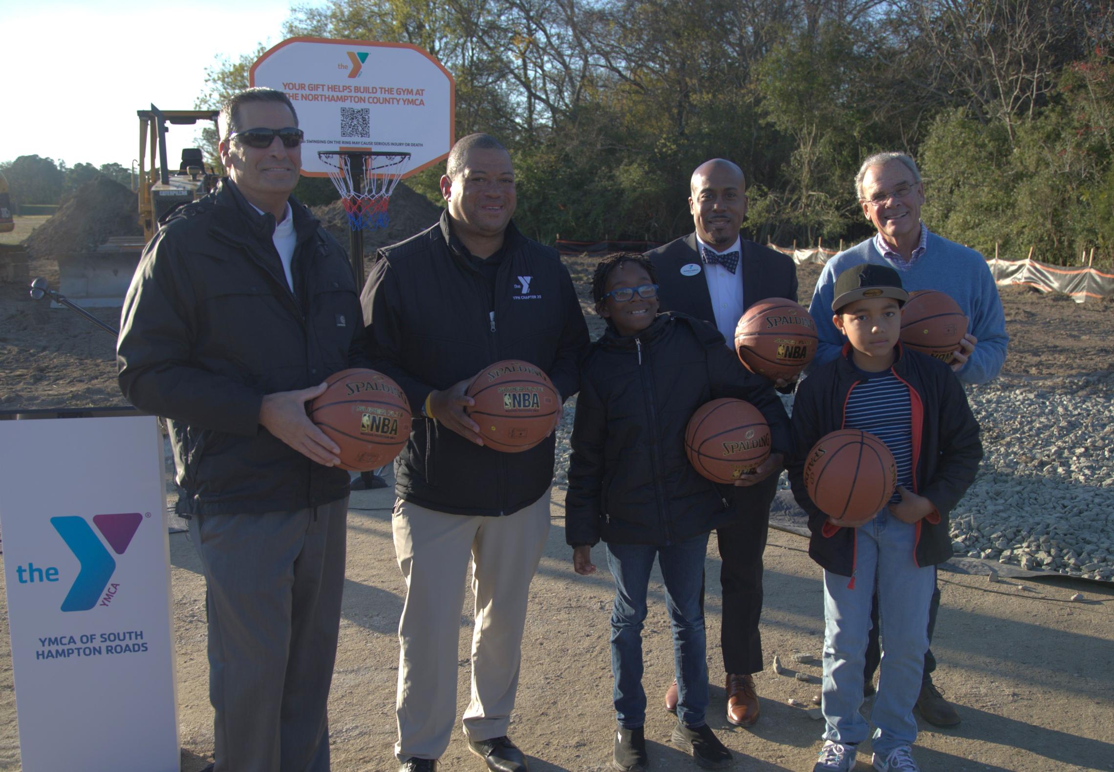 Y Staff and community members gather to break ground on a new gym.