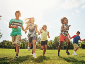 Kids playing in the grass having fun