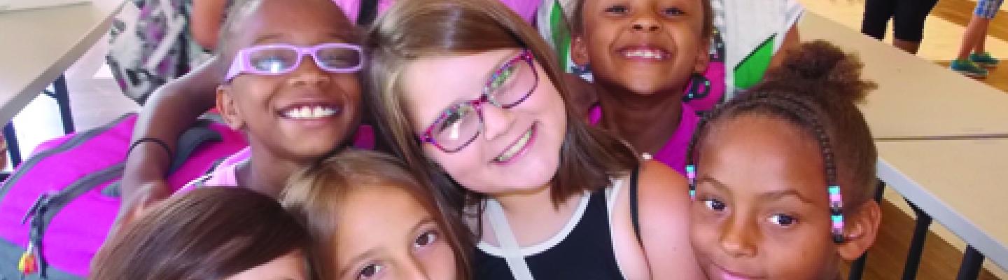 A group of girls smile at the camera at the Y
