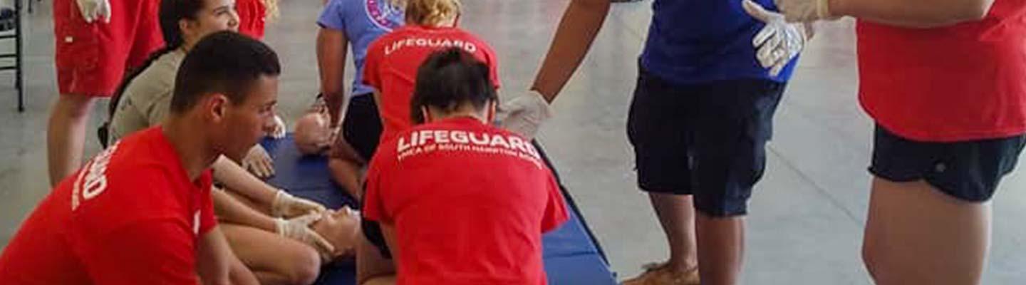 Dozens of YMCA lifeguard taking a CPR class