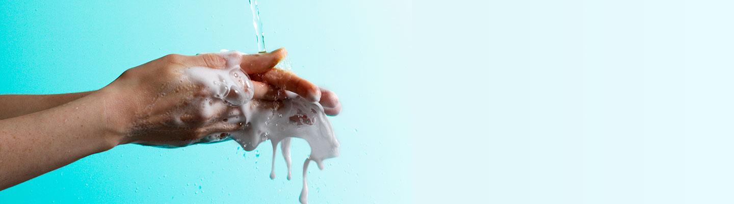 Picture of hands washing with soap under stream of water