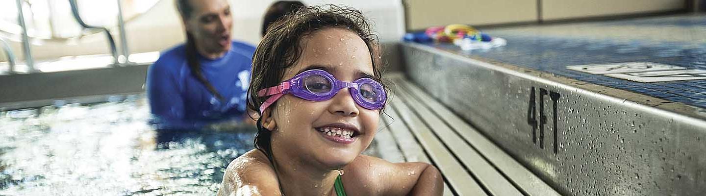 Photograph of young person enjoying swim lessons at the YMCA.