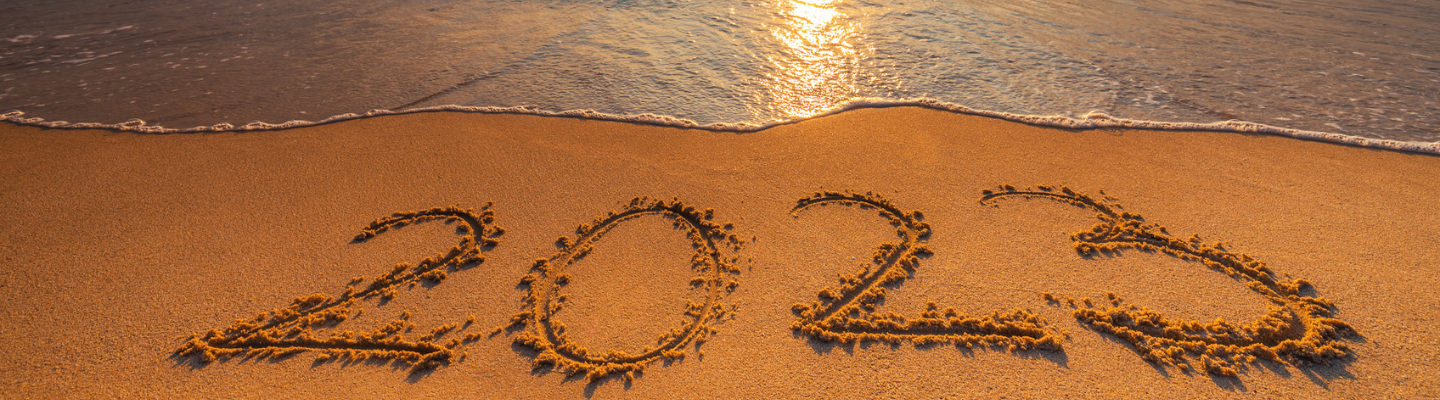 The beach with the year 2023 written in the sand