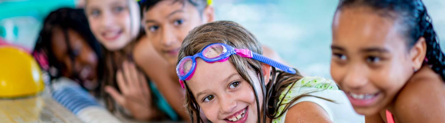 Smiling kids in swimming pool