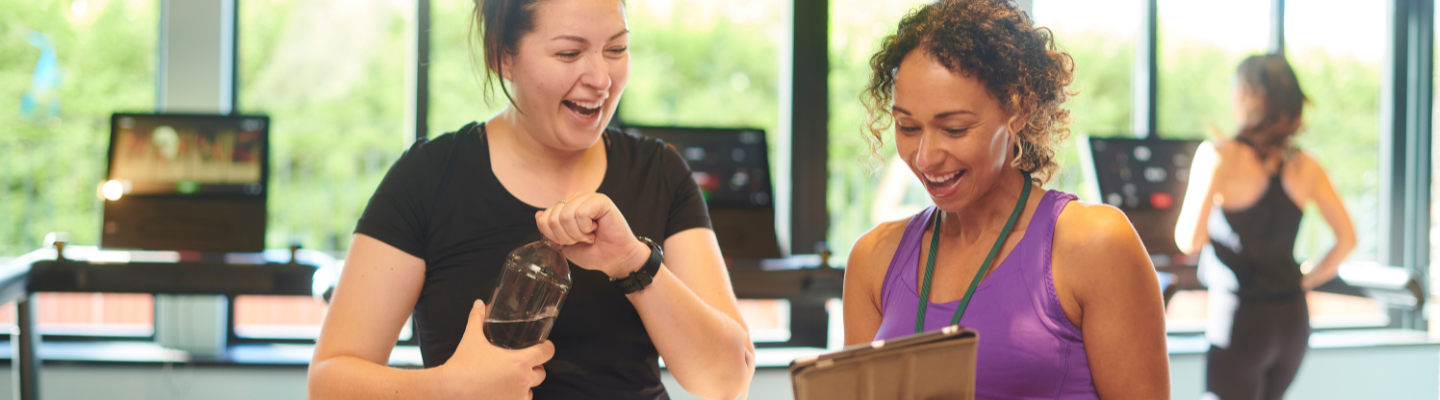 Female personal trainer with female client in the gym