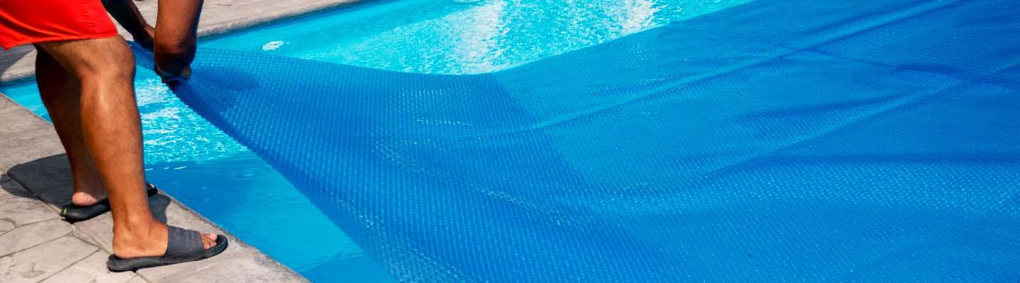 Lifeguard covering up an outdoor pool