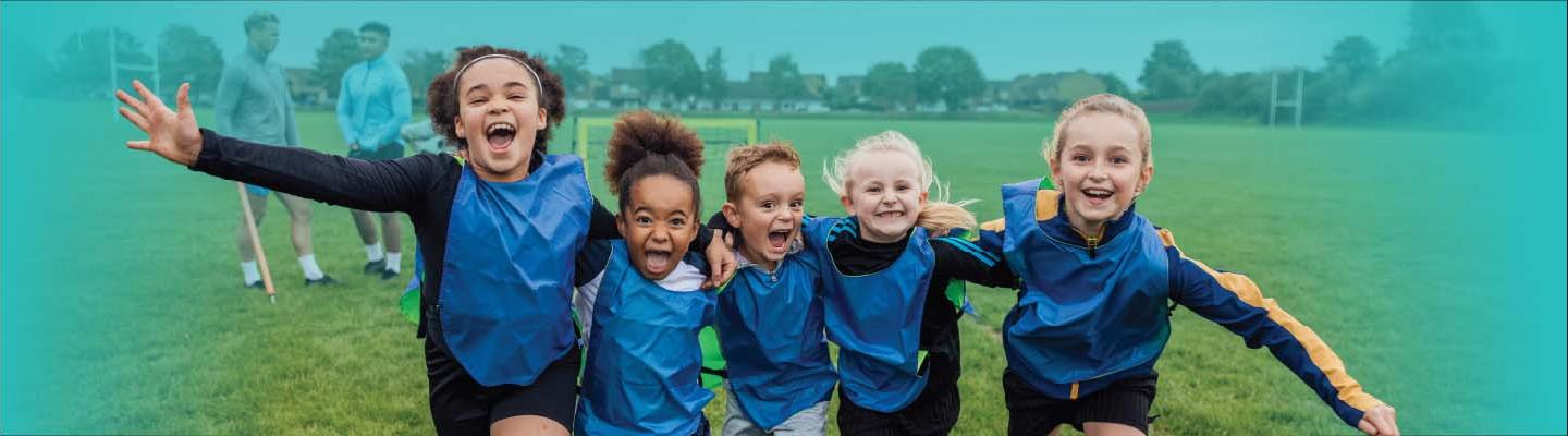 4 Kids having fun on the soccer field 