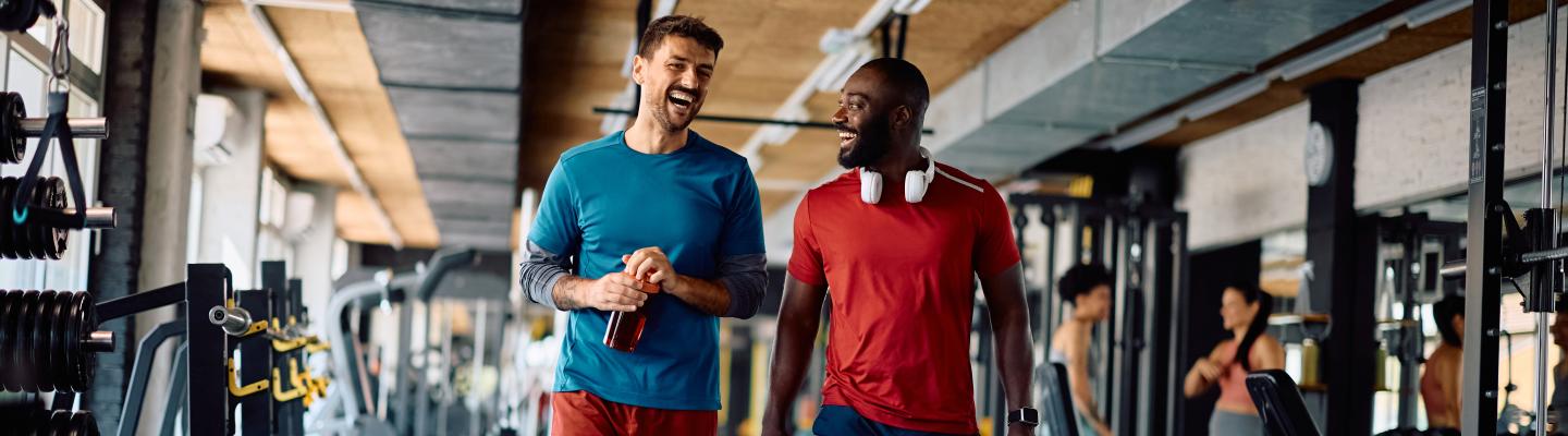 Friends walk and laugh in the free weight center