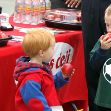 Kids eating apples at a YMCA event