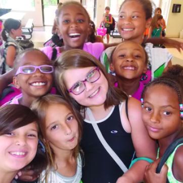 A group of girls smile at the camera at the Y