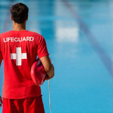 Back shot of a lifeguard watching over the pool