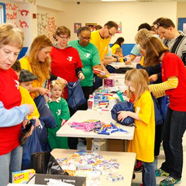 large group of people in a YMCA center doing crafts