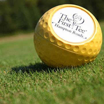 The First Tee logo golf ball in the grass
