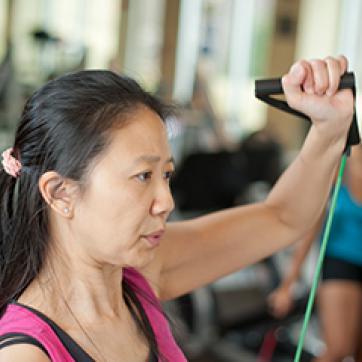 Woman using a cardio resistance band