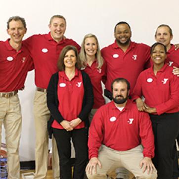 YMCA staff members in a group photo wearing red shirts