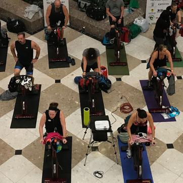 Large cycle class event with stationary bikes on mats