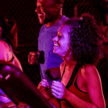 Group of adult friends running on treadmills