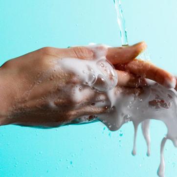 Picture of hands washing with soap under stream of water