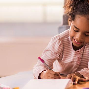 Young girl coloring with markers