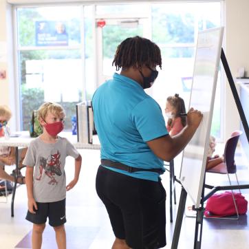 Staff helps child solve problem