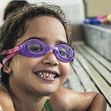 Photograph of young person enjoying swim lessons at the YMCA.
