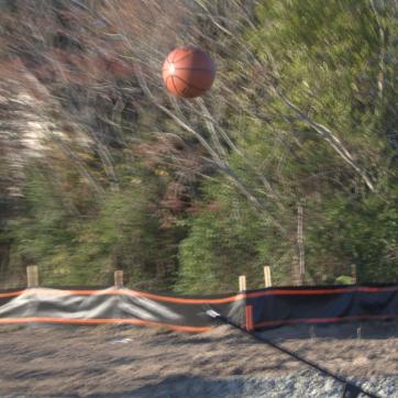 Youth shoots basketing into a hoop during NHC YMCA Groundbreaking