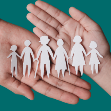 Hands holding paper doll family