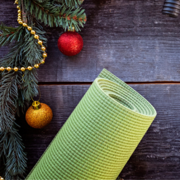 yoga mat with ornaments and garland with a wooden background