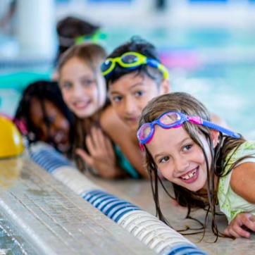 Smiling kids in swimming pool