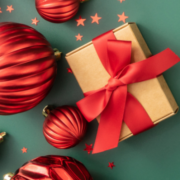 Green background with red ornaments, a present, and red star confetti