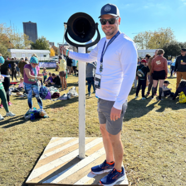 Patrick Garrison, member of the YMCA of South Hampton Roads ringing a bell after his half marathon