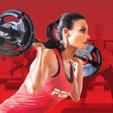 Woman wearing Group Power shirt squats with barbell on her shoulders