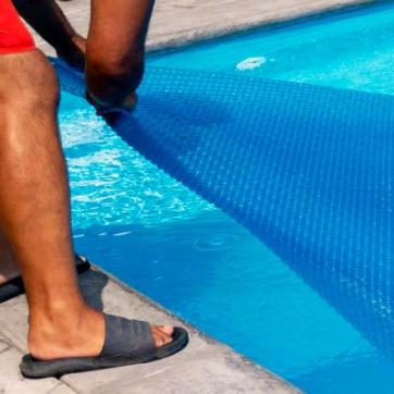 Lifeguard covering up an outdoor pool