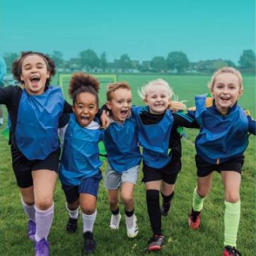 4 Kids having fun on the soccer field 